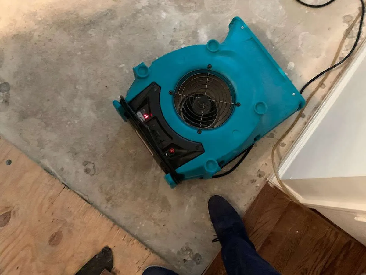Air mover drying subfloor during Commercial Water Damage Restoration in Barre